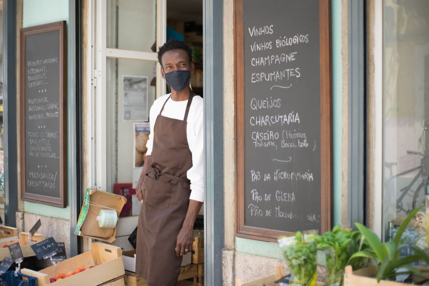 An owner standing in the doorway of his cafe
